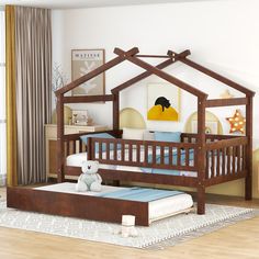 a child's bed with a wooden frame and canopy