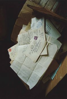 an open box filled with lots of papers and envelopes on top of each other