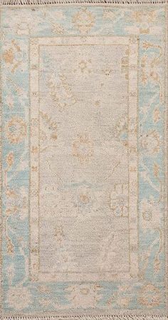 an antique rug with blue and beige colors