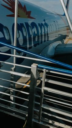 an airplane is parked on the tarmac with stairs leading up to it's door