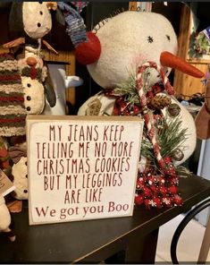 two snowmen are next to a sign that says, my jeans keep telling me no more christmas cookies but my leggings are like we got you boo