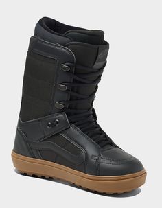 a pair of black snow boots with brown soles