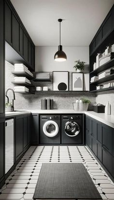 a black and white laundry room with washer and dryer on the floor in front of shelves