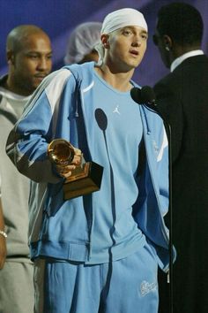 a man holding an award in his hand