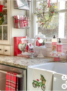 the kitchen counter is decorated for christmas with red and white dishes, cups, napkins and baskets