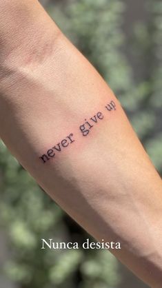 a person's arm with the words never give up on it