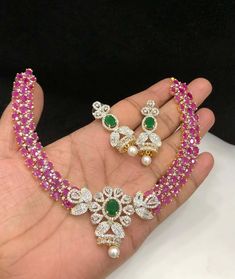 Gorgeous Gold Plated necklace set studded with Faux ruby, emerald stones with Zirconium / American Diamonds detailing and cute pearl drop. Necklace base metal is brass. This necklace is full of lusture and real looking. Style this elegant necklace set with any Indian Attire.  👉🏻Closure: Specialty Chain Or Adjustable dori.  ✅ SOURCING & PACKAGING  👉🏻Ethically Sourced, Indian high quality raw materials used. 👉🏻All items arrive in meticulously packed gift box with utmost attention to details. ✅Shop our collection here: https://www.etsy.com/shop/KKsCulture 💕Send us an email if you need help! ✅ Contact Us: +1 (732) 325-2222 Diamond Necklace Set Indian, Ruby Emerald Necklace, Emerald Necklace Set, Necklace Set Indian, Pearl Drop Necklace, Diamond Necklace Set, Ruby Emerald, Emerald Necklace, Elegant Necklace