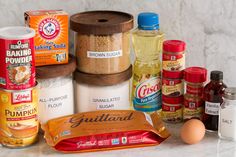 an assortment of food items sitting on top of a white marble counter next to each other