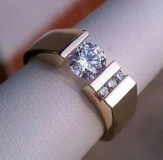 a close up of a ring with a diamond on it