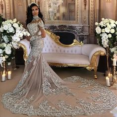 a woman in a wedding dress standing next to a couch