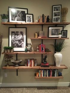 the shelves are filled with books and pictures