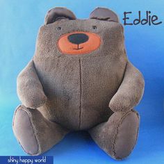 a brown teddy bear sitting on top of a blue background with the words eddie written above it