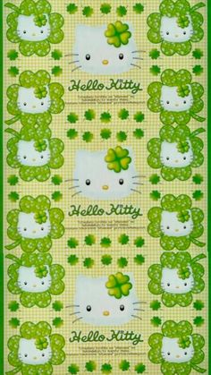 a green and white poster with hello kitty on it's face, surrounded by shamrocks