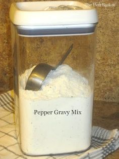 a canister filled with white powder and a spoon