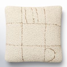 a white pillow with squares and lines on it