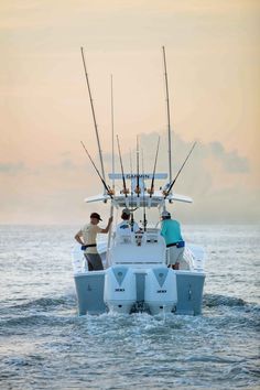 two men fishing on a boat in the ocean