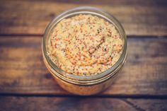 a glass jar filled with food on top of a wooden table