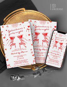 two red and white wedding cards on a gold platter next to a cell phone