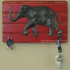 an elephant key holder is hanging on the wall