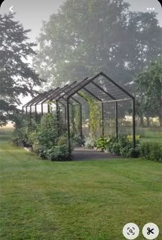 a small wooden structure sitting on top of a lush green field