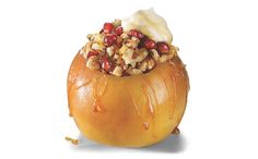 an apple with nuts and cream on top