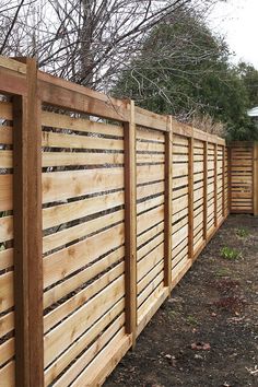 a wooden fence in the middle of a yard