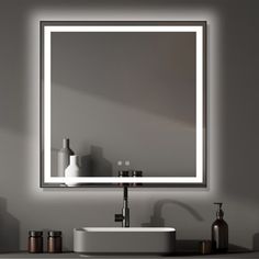 a bathroom sink with a lighted mirror above it