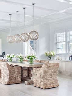 a dining room table with chairs and chandelier hanging from the ceiling