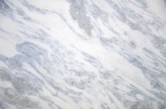 a white marble counter top with grey veining