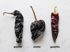 three different types of chili peppers on a white counter top with the names of them