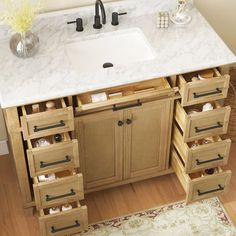 a bathroom vanity with drawers and a sink