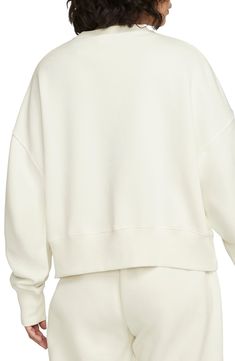 An embroidered Swoosh adds minimal branding to this cozy fleece sweatshirt cut for a relaxed, oversized fit that's enhanced by the dropped shoulders. 22" length (size Medium) Crewneck 80% cotton, 20% polyester Machine wash, tumble dry Imported Nike Solid Sweats For Fall, Nike Solid Color Sweats For Fall, Nike Solid Color Fall Sweats, Nike Relaxed Fit Fleece Sweats, Nike Fleece Tops With Relaxed Fit, Nike Fleece Relaxed Fit Top, Nike Relaxed Fit Fleece Tops, Nike Oversized Fleece Tops, Nike Oversized Sportswear Sweatshirt