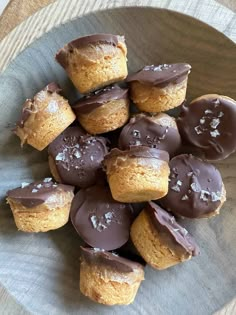 a plate filled with chocolate covered cookies on top of a wooden table