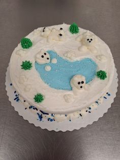 a frosted cake decorated with white and blue icing