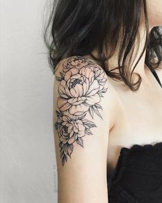 a woman with a flower tattoo on her arm