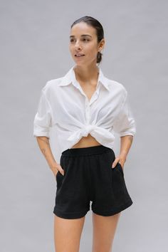 The Clara Shirt is a true modern classic. Crafted from semi-sheer organic cotton, it adds an alluring touch to any look. Whether it is casually knotted, loosely draped as a cover-up, or tucked neatly into jeans, the Clara Shirt is a travel staple you can always count on. Semi-sheer Drop shoulders Square hem Natural shell buttons True to size - relaxed fit Pictured: XS/S Rippled Water, Natural Detergent, Beach Essentials, Travel Wardrobe, Shell Buttons, Dyeing Process, Body Size, Black Shorts, Modern Classic