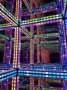 colorful lights are shining on the ceiling in an art installation, with multiple colors and shapes