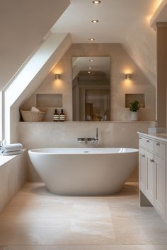 a large white bath tub sitting under a window in a bathroom next to a sink