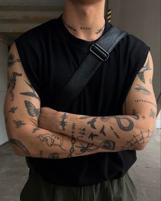 a man with tattoos on his arms and chest