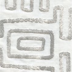 a close up view of an embroidered fabric with squares and rectangles on it