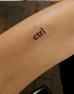 a woman's arm with the word girl written on it, in cursive font