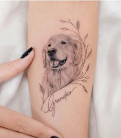 a woman's arm with a tattoo of a dog and the words grandma on it