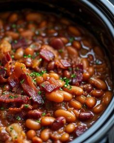 a crock pot filled with beans and bacon