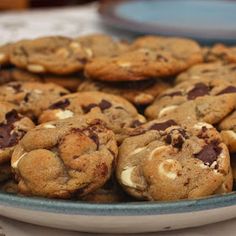 chocolate chip cookies with marshmallows in a blue and white bowl on a table