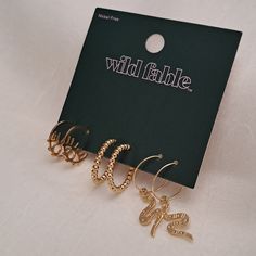 Nwt 3-Piece Set Of Goldtone Pierced Earrings (Gold) - Wild Fable 3 Different Gold Color Earrings. One Pair Of Wires With Dangling Snakes, One Pair Of Hoops That Appear Beaded And One Pair With An Eye Design. Nickel Free Brand New In Original Packaging! Bundle Any 2 Items Marked [2 For $10] And Send Me A $10 Offer - I Will Accept! All Sales Are Final Per Posh Policy. Thank You! Wild Fable, Eye Design, 3 Piece, Earings Piercings, Gold Color, Gold Earrings, Gold Tones, Jewelry Earrings, Women Jewelry