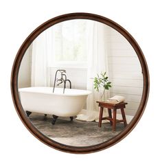 a bathroom with a bathtub, stool and window in the reflection on the wall