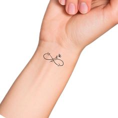 a woman's arm with a small tattoo on it