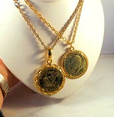 Heavy gold tone necklaces with gold clad Eisenhower Dollars.  Your choice of design. 1) 1974 Eisenshower Dollar showing the reverse of the coin - the eagle landing on moon.  Thick rope chair surround the coin.  Very large bail.  Comes with a gold tone prince of wales link chain with a spring ring.  The pendant measures about 2 3/4" long by about 1 7/8" wide; chain is 24" long.  Very good condition. 2) 1972 Eisenhower Dollar showing the obverse of the coin - Eisenhower's head.  Thick twist rope surround the coin.  Smaller bail.  Comes with a gold tone prince of wales link chain with a spring ring.  The pendant measures about 2 1/4" long by about 1 7/8" wide; chain is 24" long.  Very good condition. Comes gift wrapped in a small box, perfect for gift giving. Please review all photos and use Gold Collectible Medallion Necklace, Vintage Gold Coin Necklace, Gold Coin Necklace Collectible, Vintage Gold Jewelry With Coin Pendant, Vintage Gold Plated Round Coin Necklace, Vintage Round Gold Plated Coin Necklace, Vintage Gold Coin Brass Necklace, Vintage Gold Brass Coin Necklace, Vintage Gold Jewelry With Rope Chain