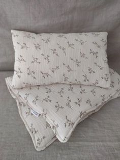 two pillows sitting next to each other on a couch