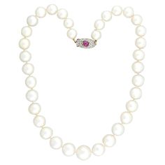 A classically beautiful and very unique South Sea Pearl convertible necklace with a gorgeous diamond and ruby clasp from the Edwardian (ca1910s) era ! This fabulous piece is comprised of a single strand of 35 substantially sized pearls which are hand-knotted on ivory-colored thread and exhibit a silvery white color and exceptional luster. The strand features a platinum-topped 18k yellow gold clasp that displays a fantastic radiant motif with intricate milgrain detail, encrusted with 20 bead-set Rose Cut diamonds and one bezel-set ruby cabochon at the center. This feminine, elegant necklace is so versatile and would look gorgeous in any pearl lover's collection! Measurements: The necklace measures approximately 18.5" in total length. The pearls range in size with 10mm being the smallest and Pearl Necklace With Diamond, South Sea Pearl Necklace, Convertible Necklace, Necklace With Diamond, Pearl Clasp, Pearl And Diamond Necklace, Necklace Clasps, Ruby Necklace, Sea Pearl